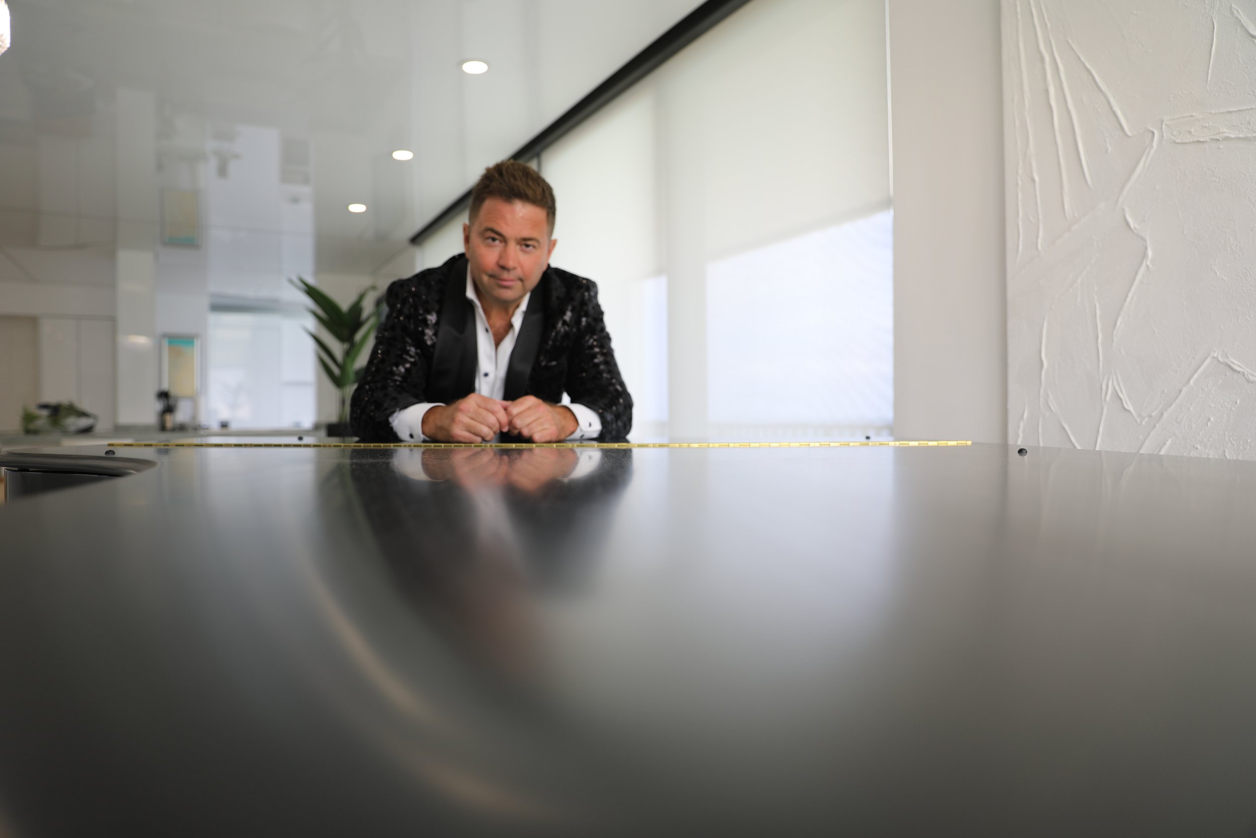 Patrick at the piano in a private suite, evening jacket